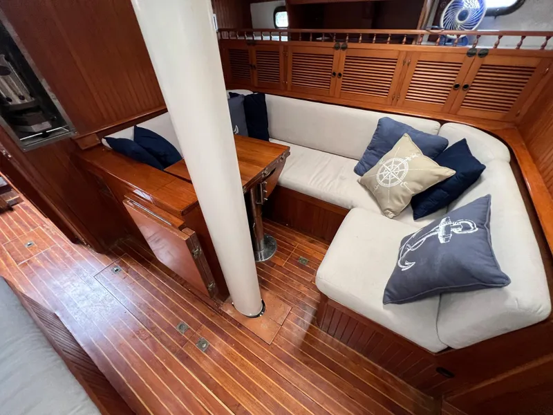 Slide: The Image of 1986 Krogen 38 interior with wooden flooring and cozy seating area. - 29
