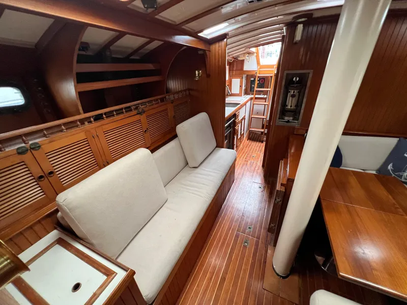 Slide: The Image of Interior of a 1986 Krogen 38 yacht with wooden finishes and white cushions. - 37