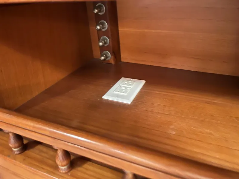 Slide: The Image of Wooden cabinet interior of a 1986 Krogen 38 boat with electrical outlet. - 41