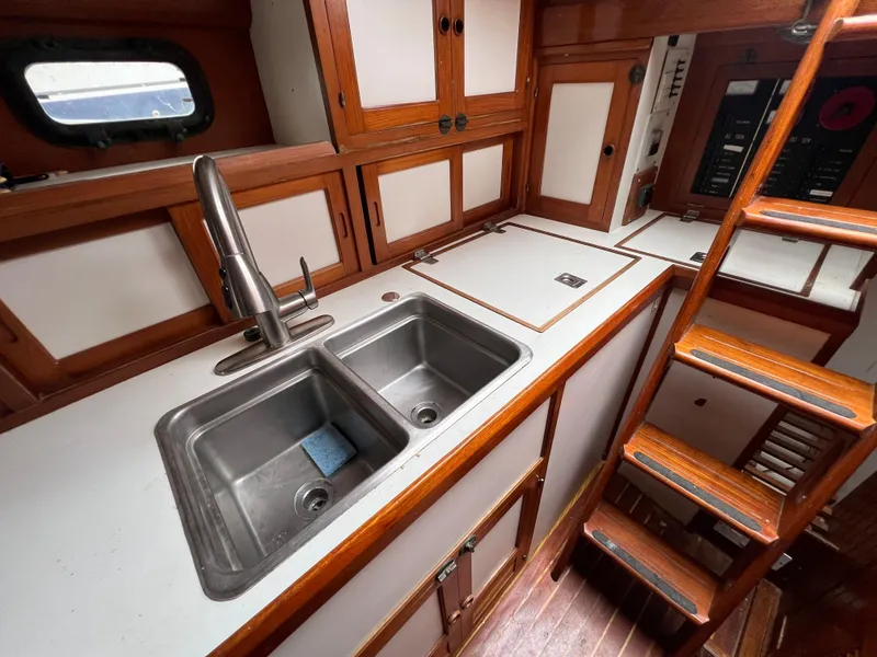 Slide: The Image of 1986 Krogen 38 yacht kitchen with double sink and wooden cabinetry. - 44