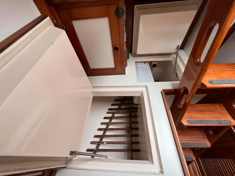 Slide: The Image of Interior of 1986 Krogen 38 boat with wooden stairs and storage compartments. - 45