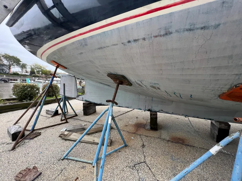 Slide: The Image of Krogen 38 boat from 1986 on stands for maintenance, showing the hull and supports. - 6