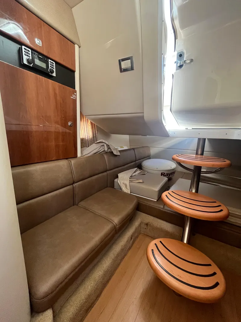 Slide: The Image of 2014 Formula 350 Crossover Bowrider cabin interior with seating and wooden steps. - 11