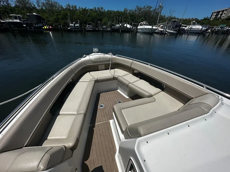 Slide: The Image of 2014 Formula 350 Crossover Bowrider with spacious seating, docked in a serene marina. - 3