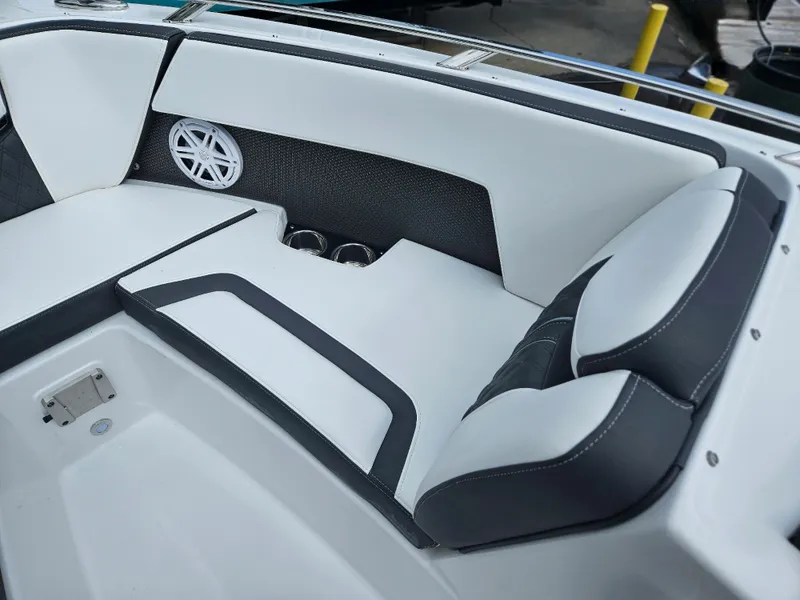 Slide: The Image of 2024 Monterey 215SS boat interior with white and black seating and speaker. - 15