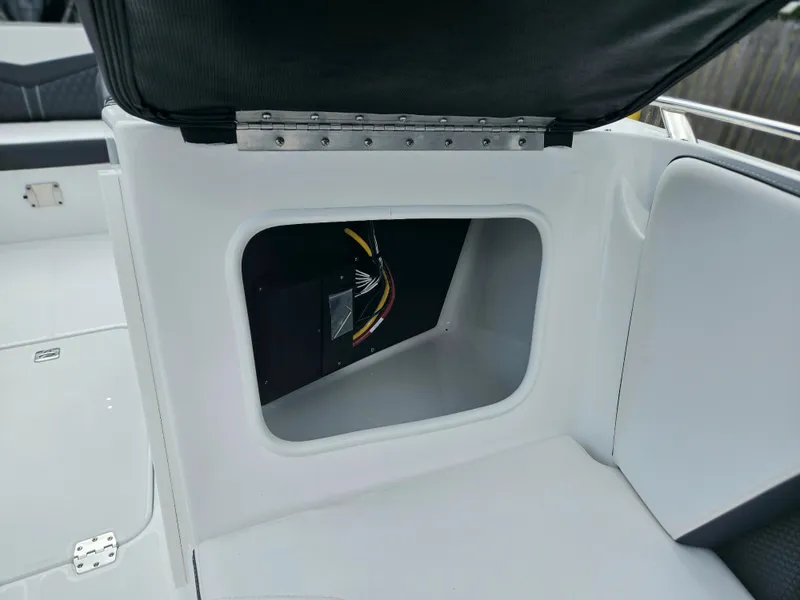 Slide: The Image of Open storage compartment in a 2024 Monterey 215SS boat. - 17
