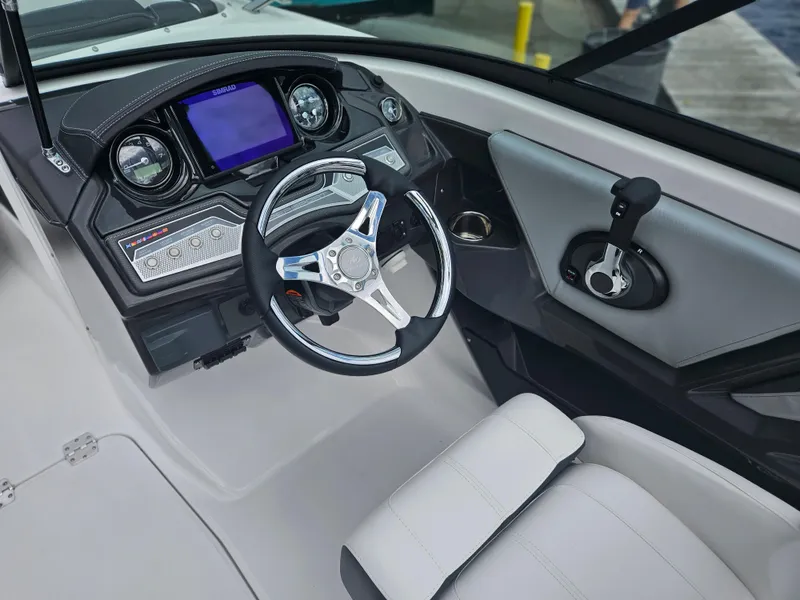Slide: The Image of 2024 Monterey 215SS boat cockpit with modern steering wheel and control panel. - 19