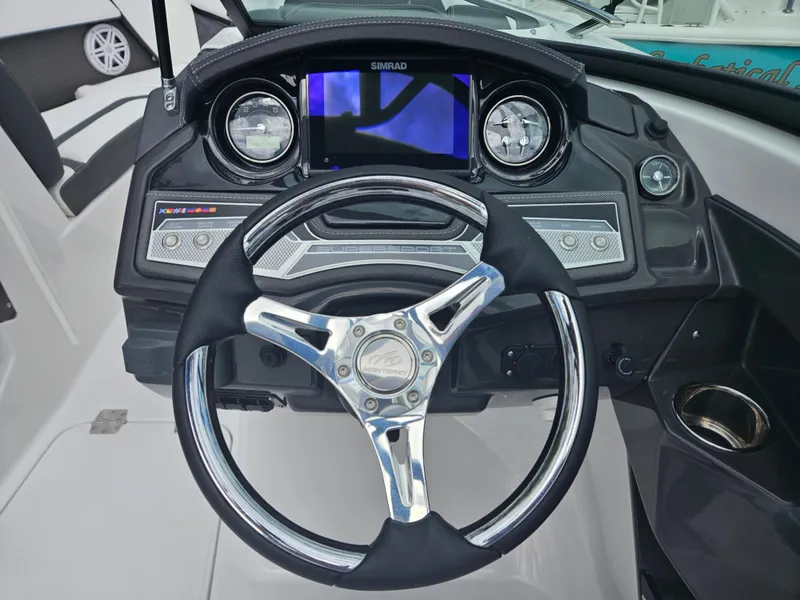 Slide: The Image of 2024 Monterey 215SS boat dashboard with steering wheel and digital display. - 20