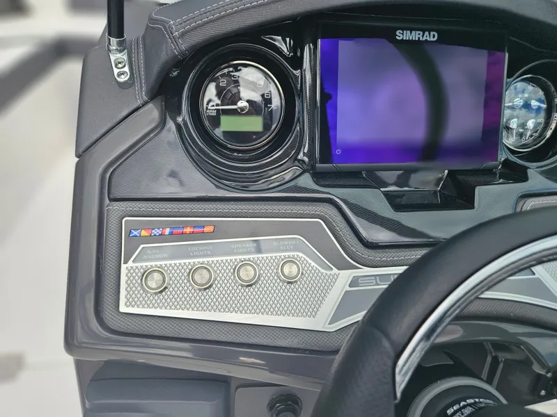 Slide: The Image of Dashboard of a 2024 Monterey 215SS boat with Simrad display and control buttons. - 21