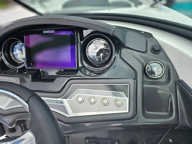 Slide: The Image of Dashboard of a 2024 Monterey 215SS boat with Simrad display and controls. - 22