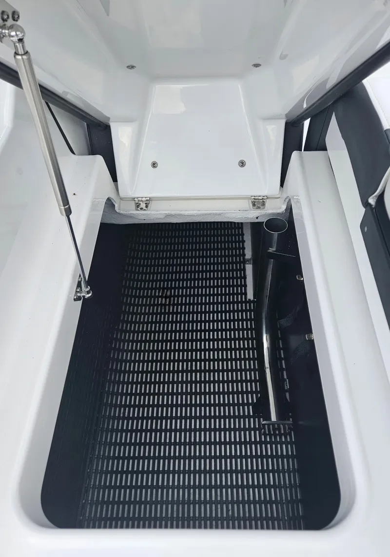Slide: The Image of 2024 Monterey 215SS boat storage compartment with black mat. - 30