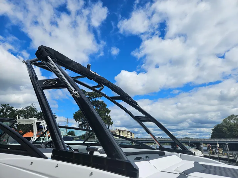 Slide: The Image of 2024 Monterey 215SS boat with wakeboard tower against blue sky. - 8