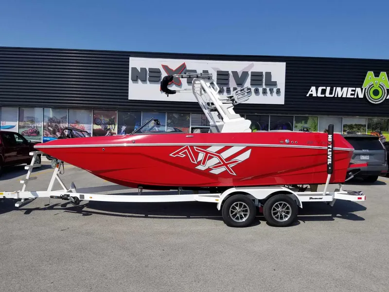 Slide: The Image of 2024 ATX Surf Boats 22 Type-S in vibrant red on a trailer outside dealership. - 1