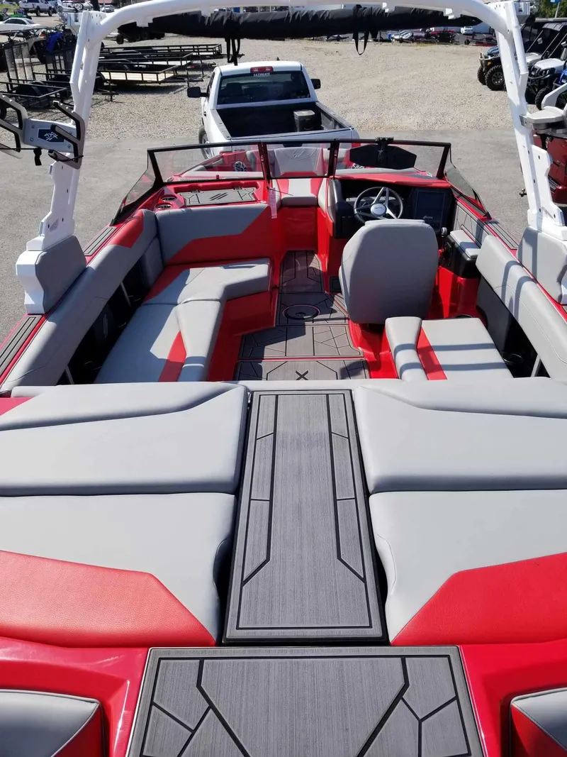 Slide: The Image of 2024 ATX Surf Boats 22 Type-S interior with red and gray seating, steering wheel, and deck. - 10