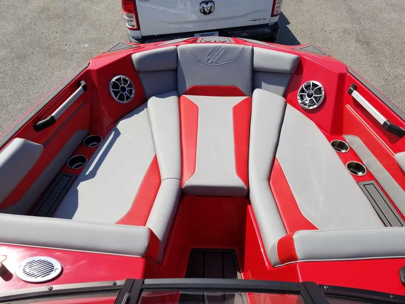 Slide: The Image of 2024 ATX Surf Boats 22 Type-S interior with red and gray seating, cup holders, and speakers. - 11