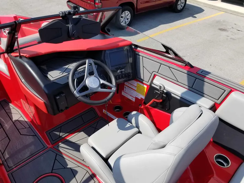 Slide: The Image of 2024 ATX Surf Boats 22 Type-S interior with red and gray design, steering wheel, and dashboard. - 13
