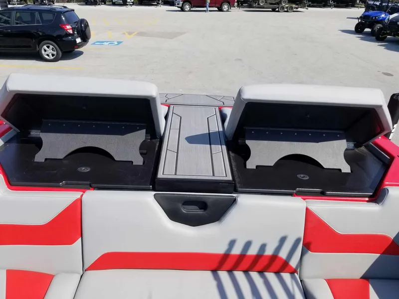 Slide: The Image of 2024 ATX Surf Boats 22 Type-S interior with red and gray seating and storage compartments. - 19