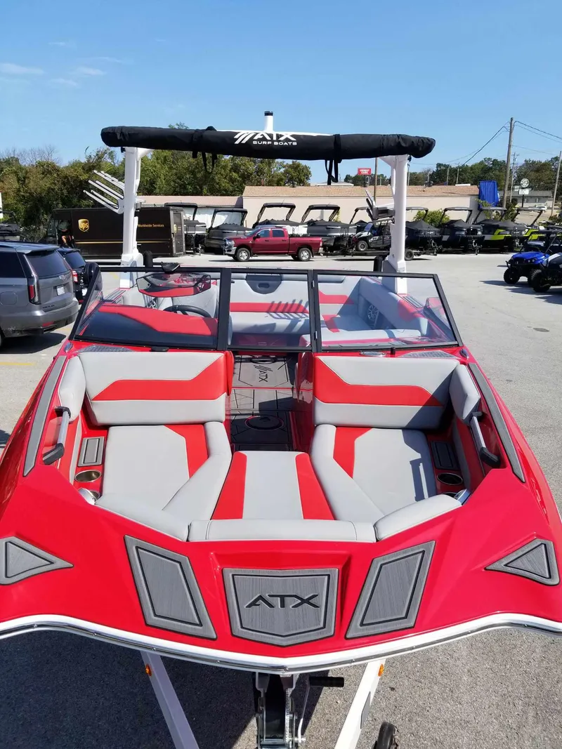 Slide: The Image of 2024 ATX Surf Boats 22 Type-S, red and gray interior, parked outdoors. - 7