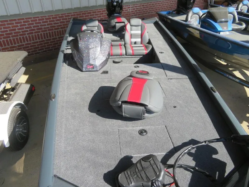 Slide: The Image of 2023 Ranger RT178C fishing boat with gray and red seating, docked beside another boat. - 5