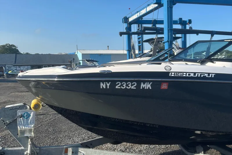 Slide: The Image of 2013 Yamaha Boats 212SS on trailer at marina, high output model. - 14