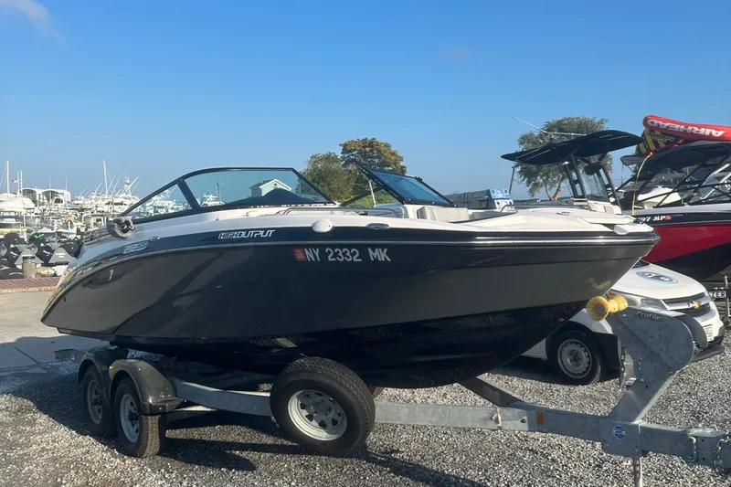 Slide: The Image of 2013 Yamaha Boats 212SS on trailer at marina, clear sky background. - 15