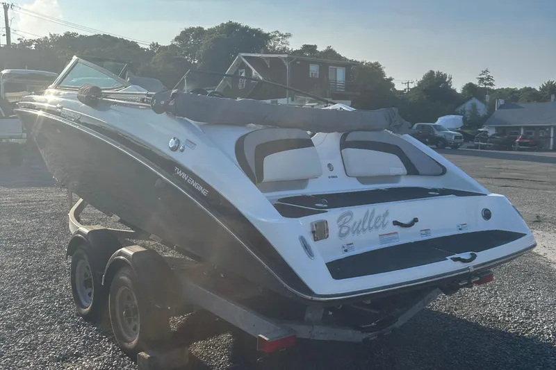 Slide: The Image of 2013 Yamaha Boats 212SS on trailer, rear view, parked outdoors. - 17