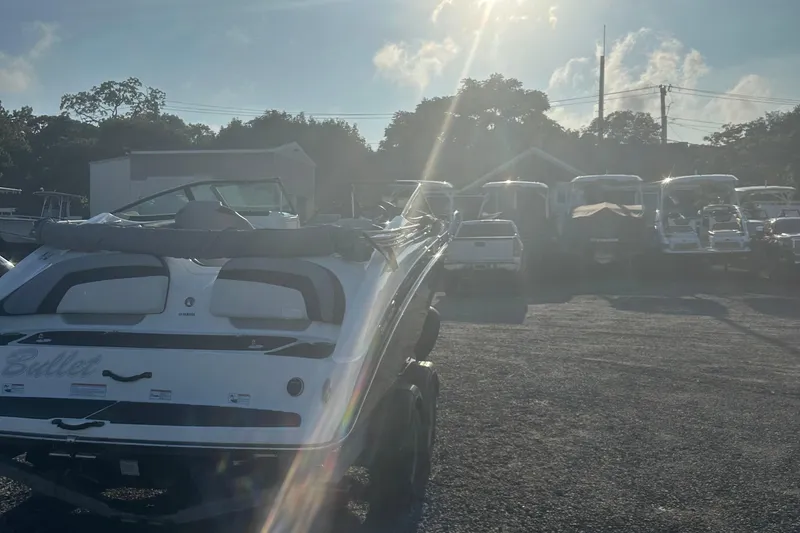 Slide: The Image of 2013 Yamaha Boats 212SS in a sunlit outdoor storage area. - 18
