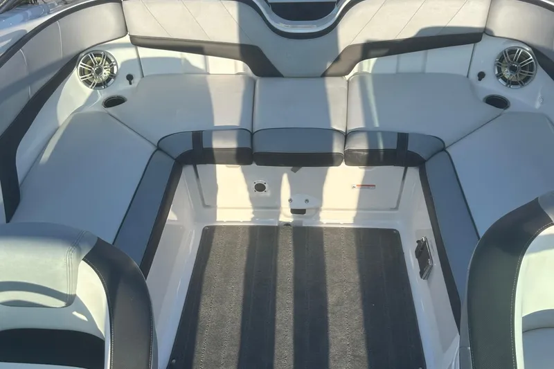 Slide: The Image of 2013 Yamaha Boats 212SS interior with gray seating and speakers. - 24
