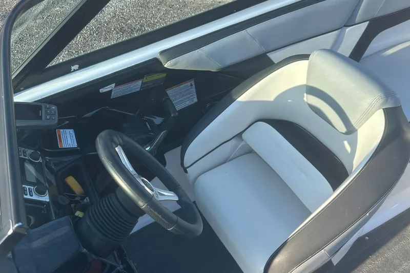 Slide: The Image of Interior of 2013 Yamaha Boats 212SS, featuring steering wheel and seating. - 31