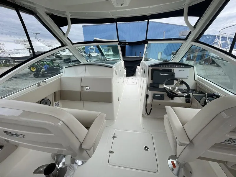 Slide: The Image of 2016 Boston Whaler 320 Vantage boat interior with helm and seating area. - 11