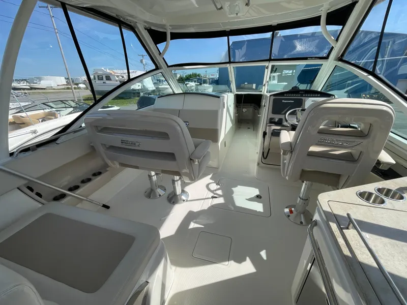Slide: The Image of 2016 Boston Whaler 320 Vantage boat interior with helm and seating area. - 12