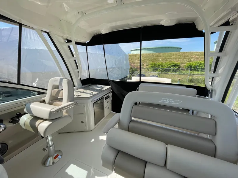 Slide: The Image of Interior of a 2016 Boston Whaler 320 Vantage boat with seating and helm station. - 13