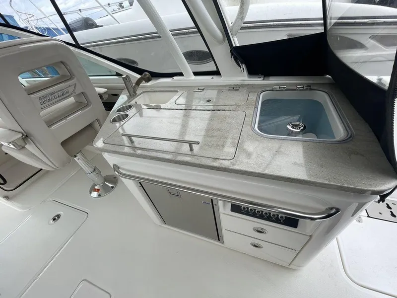 Slide: The Image of 2016 Boston Whaler 320 Vantage boat interior with kitchenette and sink. - 16