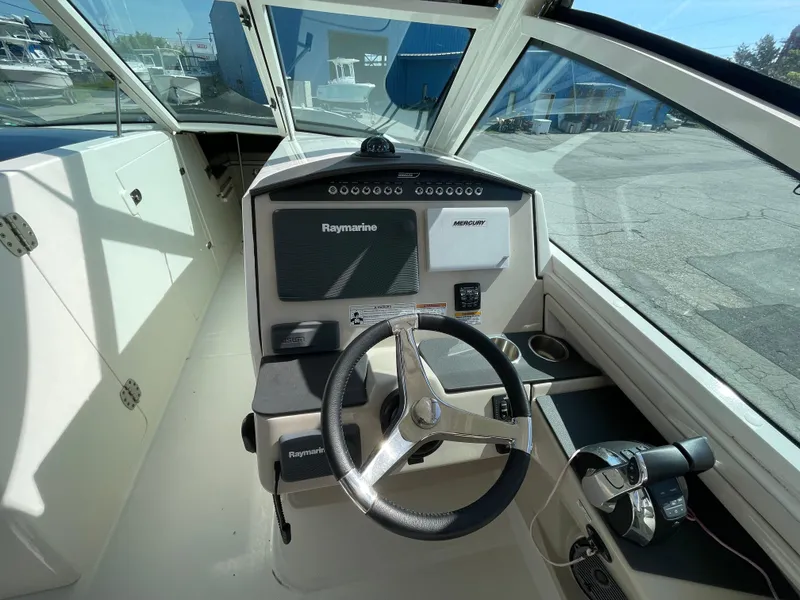 Slide: The Image of 2016 Boston Whaler 320 Vantage helm with Raymarine electronics and steering wheel. - 20