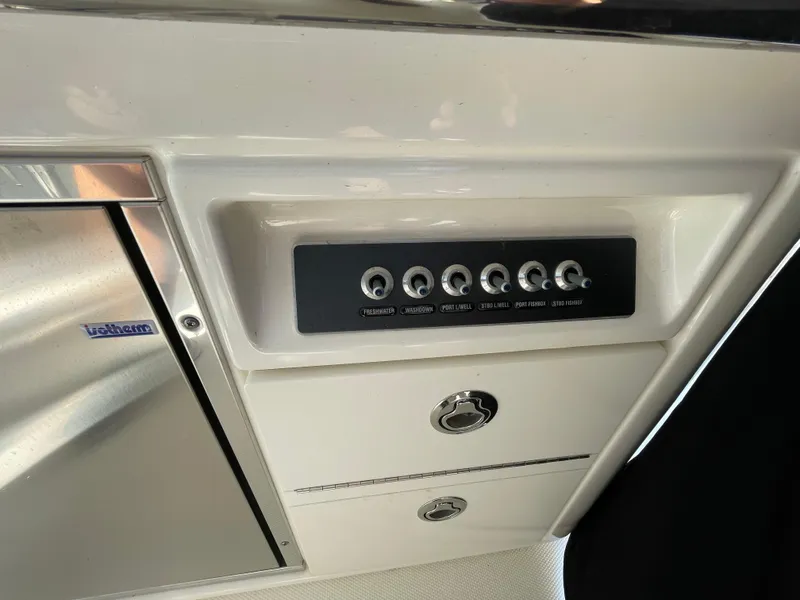 Slide: The Image of Control panel and storage compartments on a 2016 Boston Whaler 320 Vantage boat. - 24