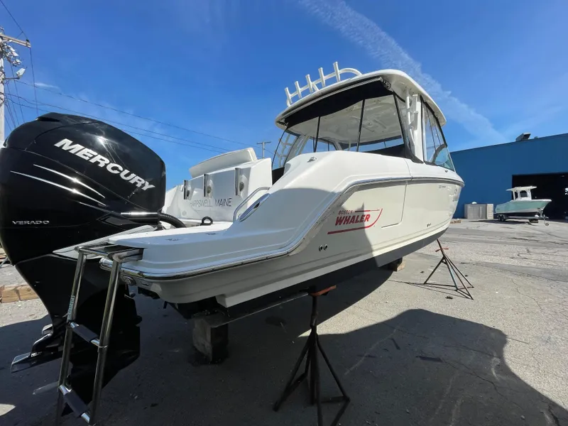 Slide: The Image of 2016 Boston Whaler 320 Vantage boat with Mercury outboard engines on stands. - 3