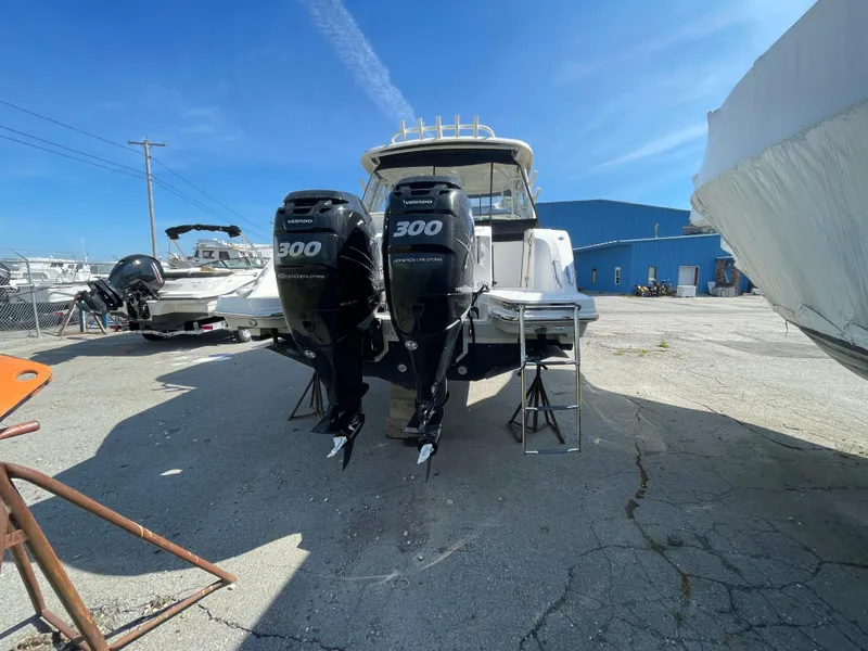 Slide: The Image of 2016 Boston Whaler 320 Vantage with twin 300 horsepower engines in a boatyard. - 4