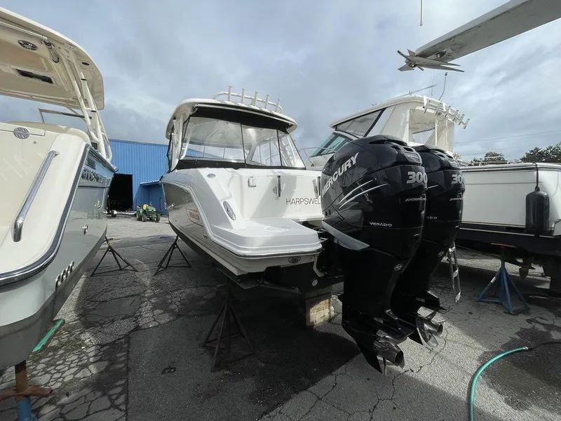 Slide: The Image of 2016 Boston Whaler 320 Vantage with twin Mercury 300 engines in a boatyard. - 5