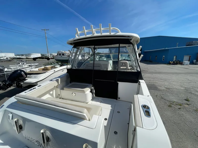 Slide: The Image of 2016 Boston Whaler 320 Vantage boat docked at a marina under clear blue skies. - 8