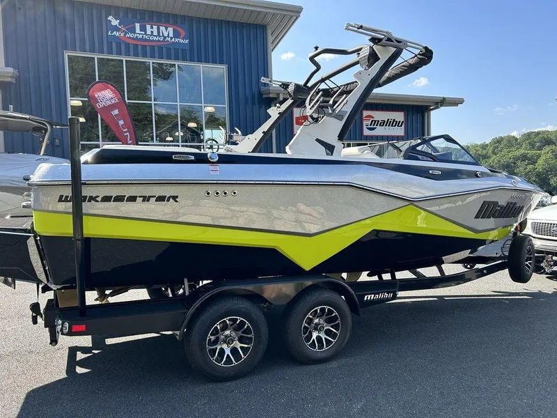Slide: The Image of 2024 Malibu 22 LSV Wakesetter boat on trailer outside dealership. - 12