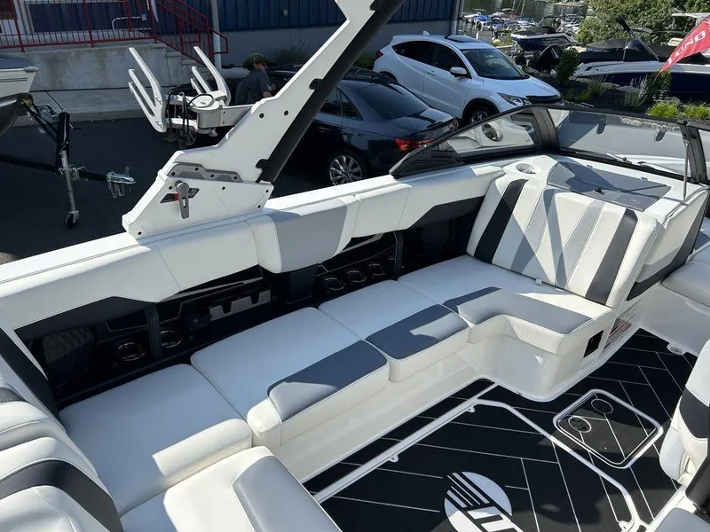 Slide: The Image of 2024 Malibu 22 LSV boat interior with white and gray seating. - 13
