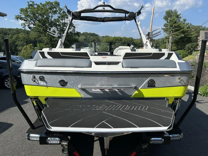 Slide: The Image of 2024 Malibu 22 LSV boat, rear view, parked outdoors. - 2