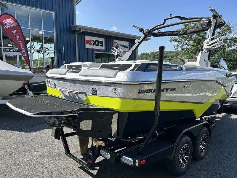 Slide: The Image of 2024 Malibu 22 LSV Wakesetter boat on a trailer outside a dealership. - 3