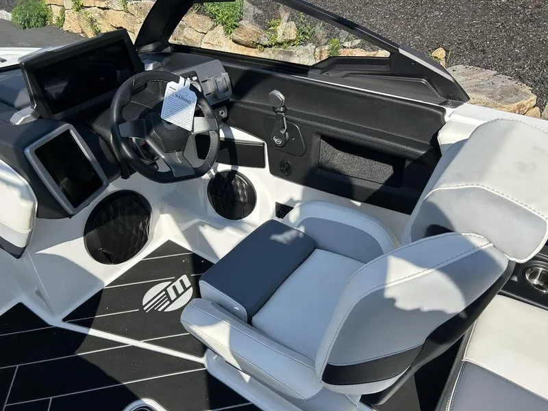 Slide: The Image of 2024 Malibu 22 LSV boat interior with modern dashboard and comfortable seating. - 8