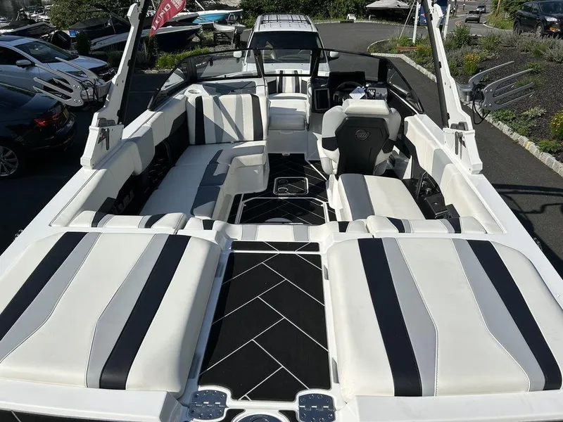 Slide: The Image of 2024 Malibu 22 LSV boat interior with white and black seating. - 9