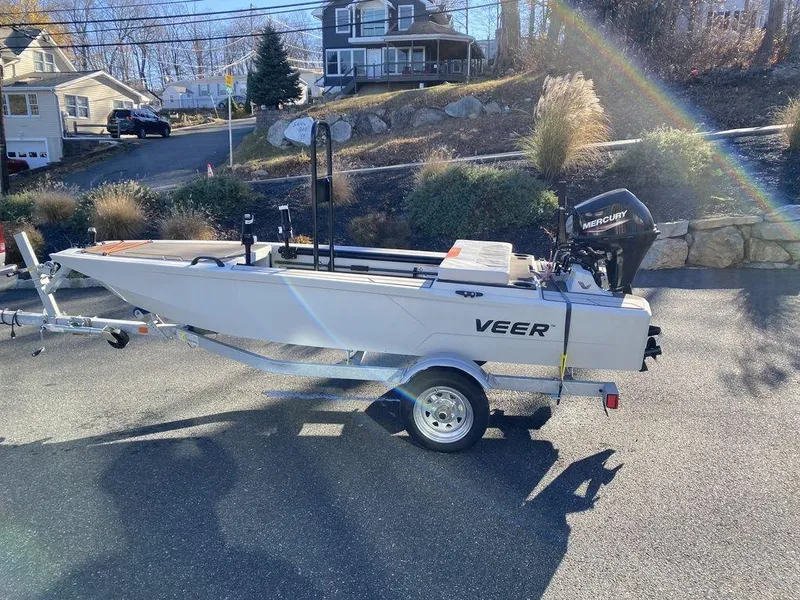 Slide: The Image of 2024 Veer V13 boat on trailer with Mercury outboard motor in residential area. - 5