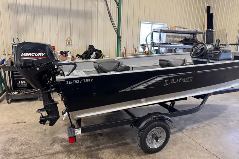 Slide: The Image of 2024 Lund 1600 Fury SS boat with Mercury engine in a workshop setting. - 26