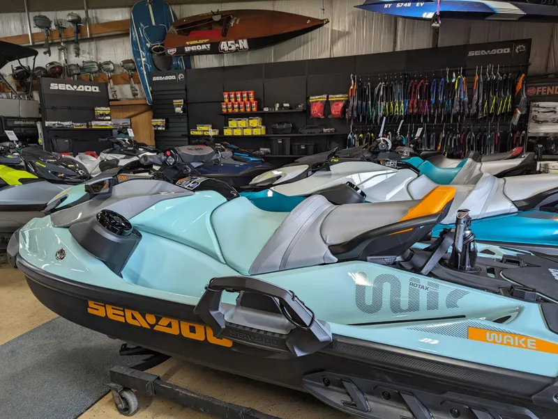 Slide: The Image of 2024 Sea-Doo Wake 170 BRP Premium Audio, iDF, iBR jet skis in showroom. - 2
