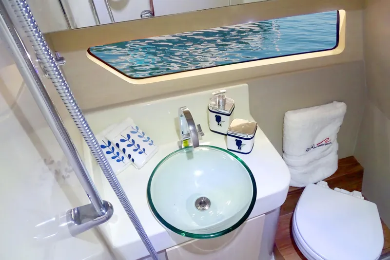 Slide: The Image of Modern bathroom on 2023 Real 35 Special Deck (SD) boat with glass sink and ocean view. - 13