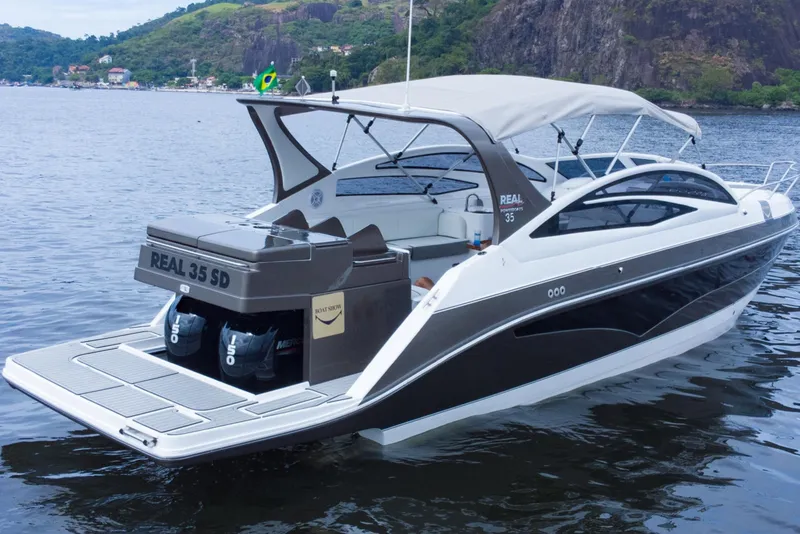 Slide: The Image of Luxury Real 35 Special Deck (SD) 2023 motorboat on serene water with scenic background. - 4